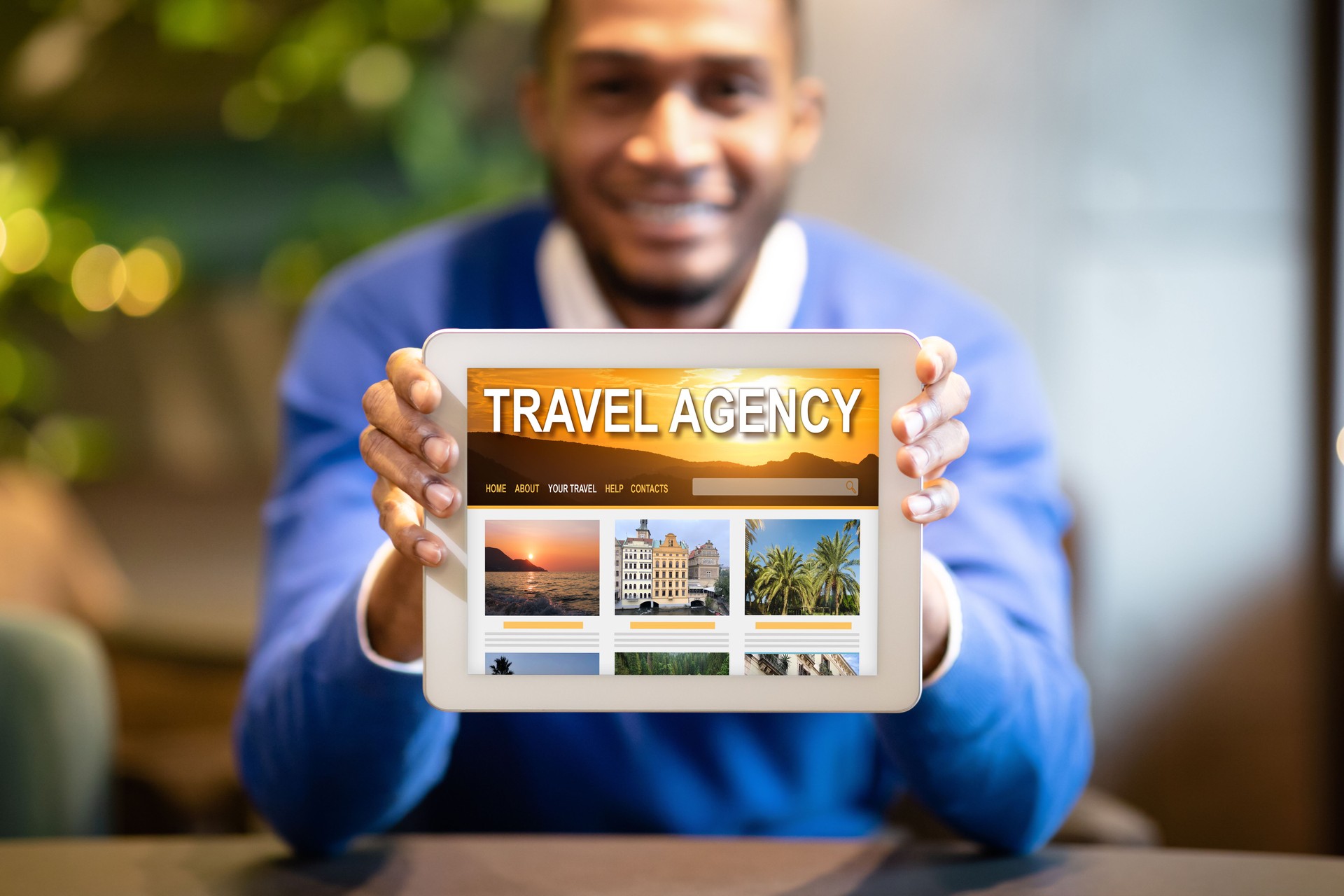 Black Man Holding Digital Tablet With Opened Travel Agency Website On Screen